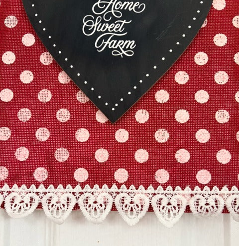 Red polka dot fabric with a black heart and white lace trim, featuring 'Home Sweet Farm' text.