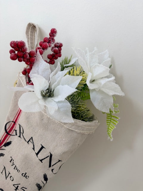 Decorative stocking with flowers and berries on a light background