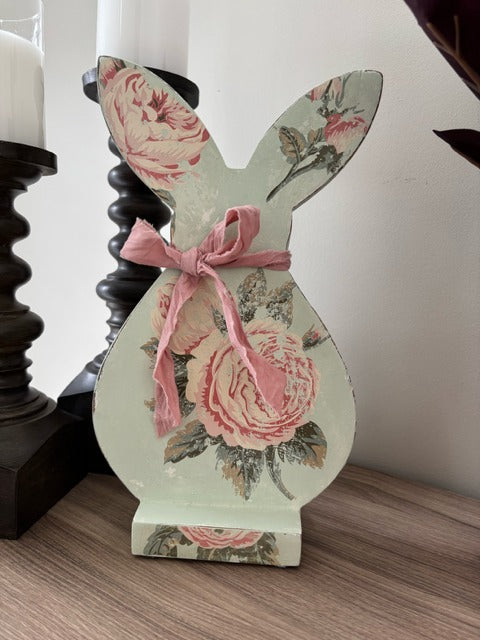Decorative bunny figure with floral design and pink bow