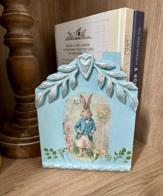 Decorative blue house with a rabbit illustration