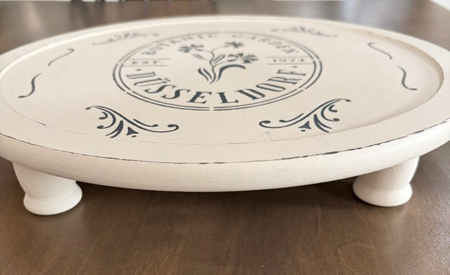 Round wooden riser with 'Dusseldorf' branding