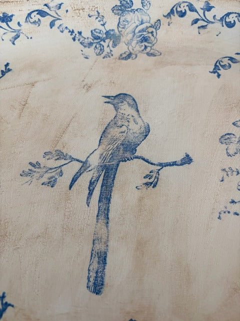 Blue bird and floral design on beige plate