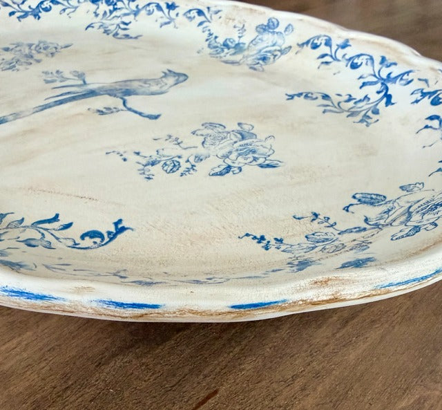 White plate with blue floral patterns on a wooden surface