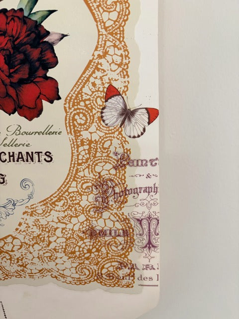 Decorative piano roll with floral design, red rose, and butterfly on a white background