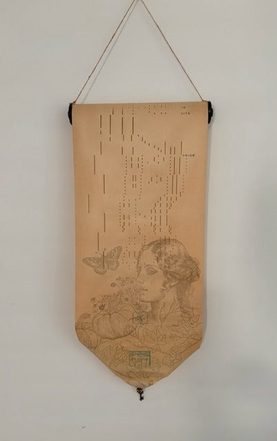 Decorative banner with intricate designs and text on a plain wall