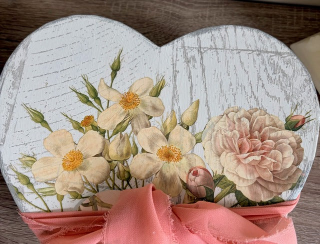 Heart-shaped box with floral design and pink ribbon 