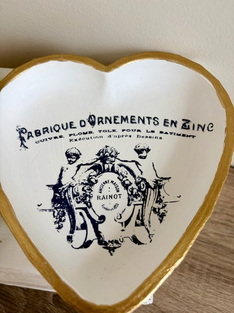 Heart-shaped dish with gold rim and navy text 