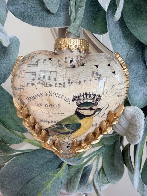 Decorative heart-shaped ornament with musical notes and a bird design