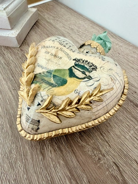 Decorative heart-shaped ornament with vintage design elements 