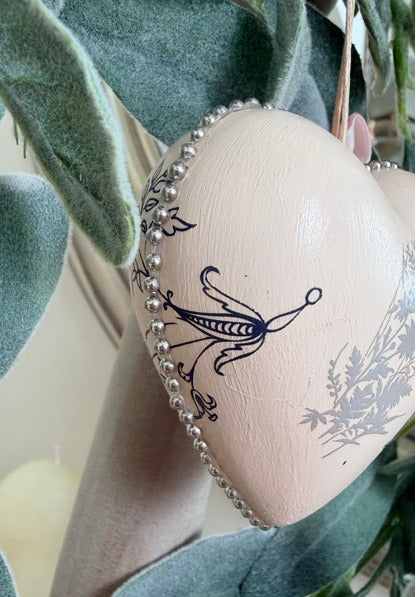 Heart ornament with beaded edge and black floral design