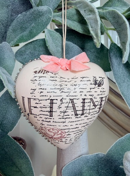 Decorative heart ornament with text and a bow 
