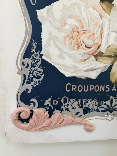 Decorative sign with floral design and text on a white background