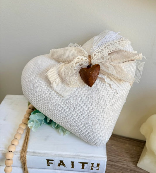 Heart-shaped decorative item with lace and a rusty heart on top