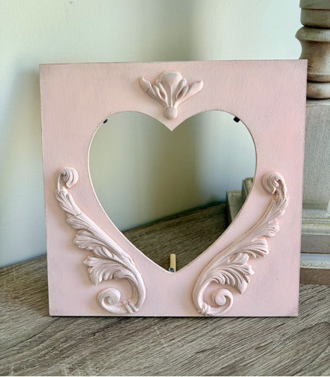 Pink decorative frame with heart shape 