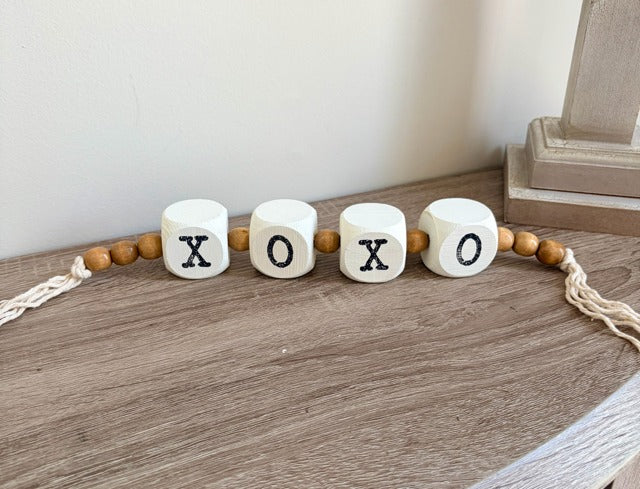 Decorative garland with 'XO' beads.