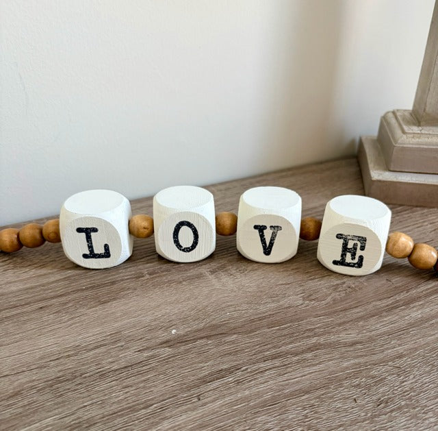 Wooden blocks with letters spelling 'LOVE' 