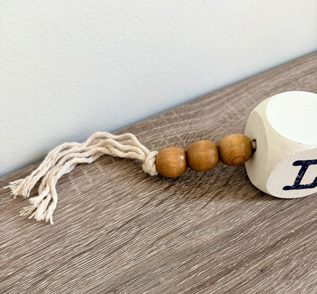 Decorative item with wooden beads and a tassel 