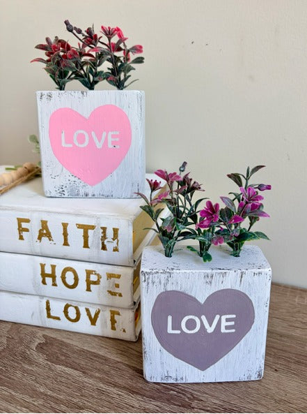 Decorative wooden blocks with 'LOVE' hearts and plants 