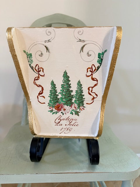 Decorative sleigh with floral and tree design 