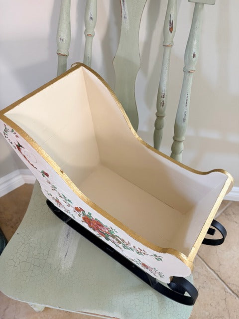 Decorative sleigh with floral design on a white background