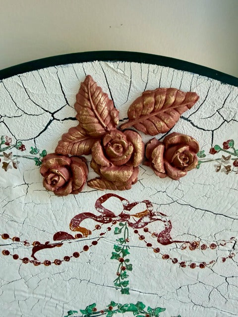Decorative elements including roses and leaves on a cracked surface with floral patterns.