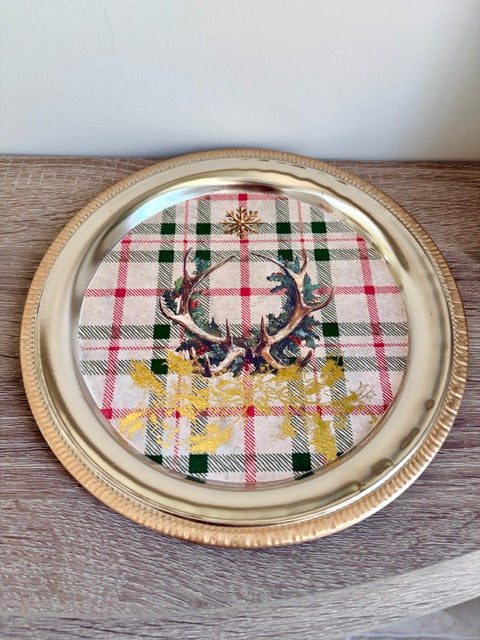 Decorative plate with a plaid design and deer emblem 