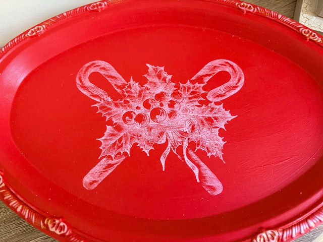 Red tray with a white floral candy cane design