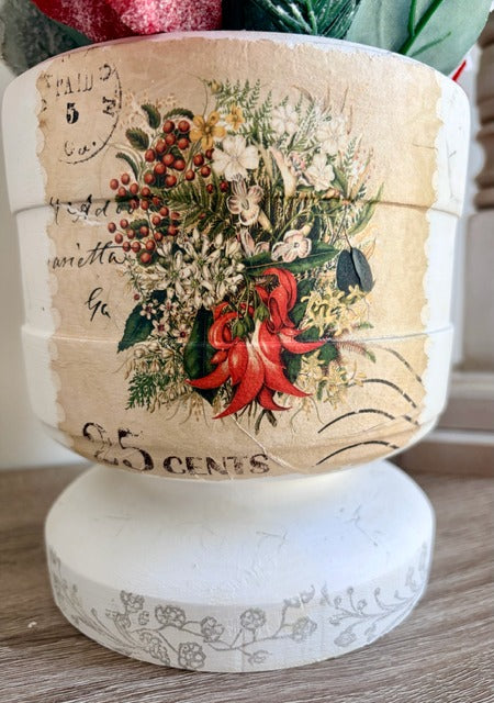 Decorative planter with floral and text design 
