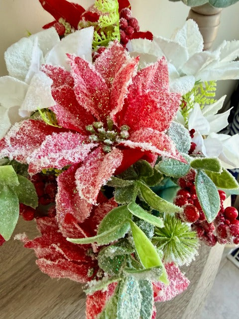 Frosted poinsettia and greenery arrangement 