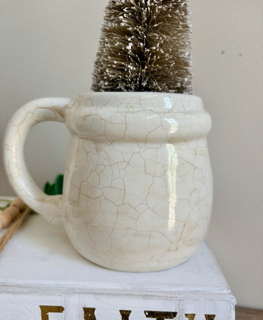 White ceramic mug with a textured surface 