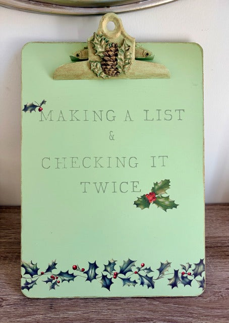 Light green clipboard with Christmas-themed decorations and text 