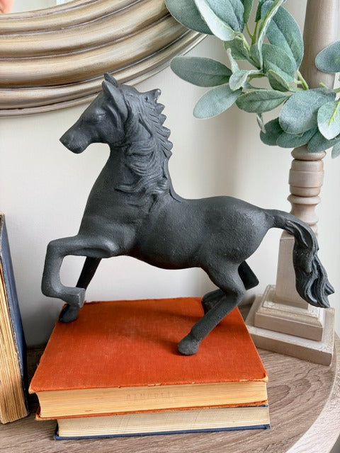 Decorative horse figure on a stack of books 
