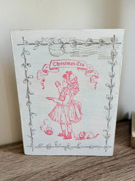 Decorative Christmas wood postcard with a red illustration of a girl and text on a white background