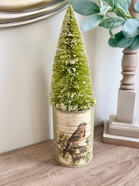 Small decorative Christmas tree in a pot with a bird design 