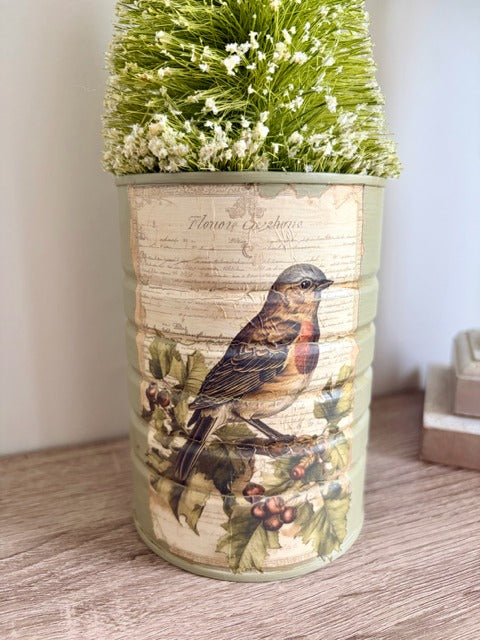 Decorative can with bird design and plant 