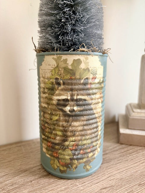 Decorative can with raccoon design 