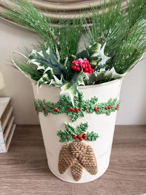 Decorative planter with Christmas-themed decorations 