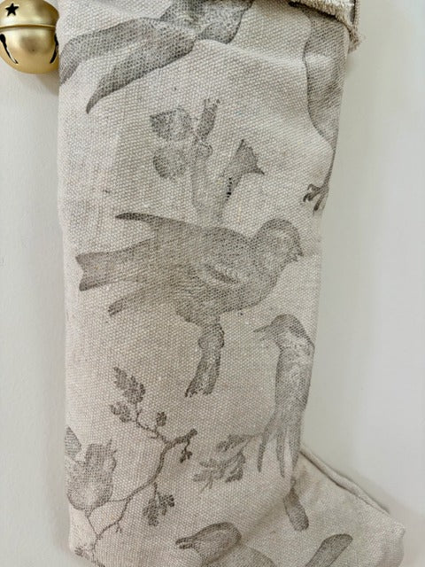 Fabric with bird pattern hanging on a white wall