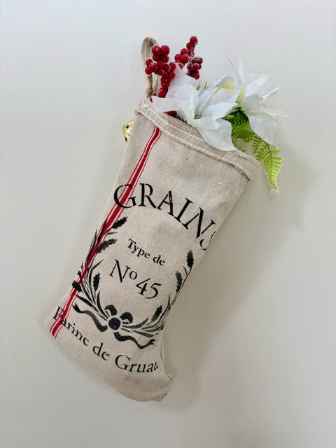 Decorative stocking labeled 'Grains' with floral elements on a white background