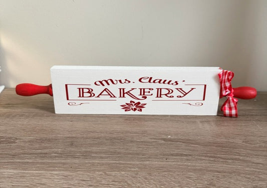 Wooden rolling pin with 'Mrs. Claus Bakery' text 
