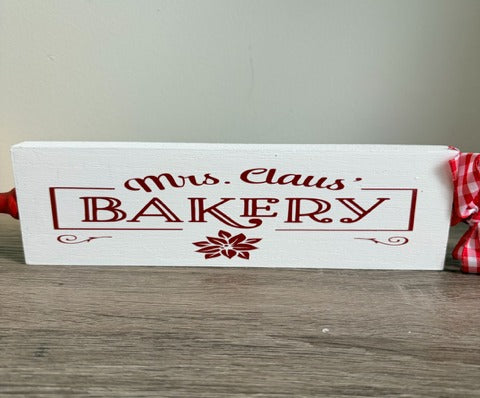 Wooden rolling pin with 'Mrs. Claus Bakery' text 