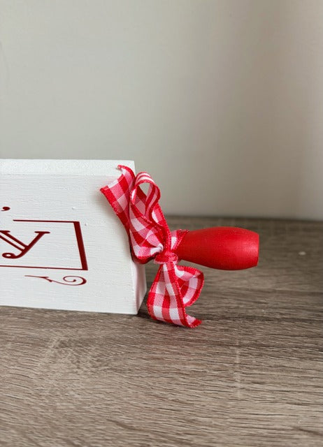 Wooden rolling pin with 'Mrs. Claus Bakery' text 