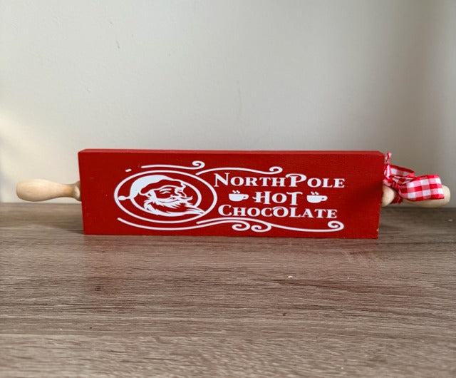 Red rolling pin with 'North Pole Hot Chocolate' text 