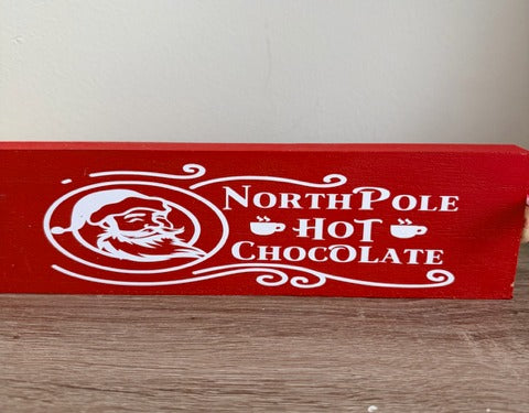 Red rolling pin with 'North Pole Hot Chocolate' text 
