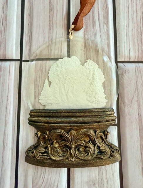 Decorative ornament hanging with a resin dome and ornate base 