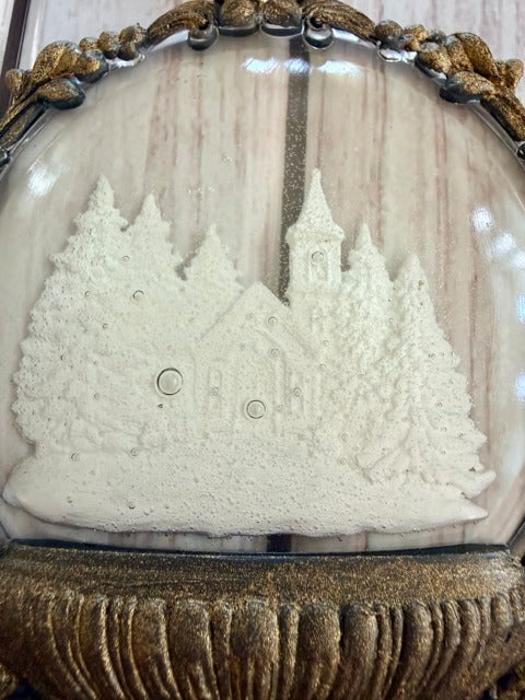 Decorative item with a church design and gold frame