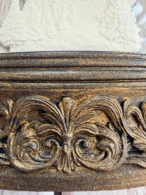 Decorative gold design on a textured surface