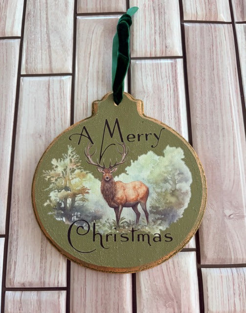Wooden Christmas ornament with deer illustration and 'A Merry Christmas' text 