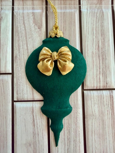 Green Christmas ornament with a gold bow 
