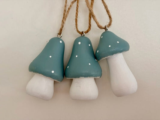 Three mushroom-shaped decorations hanging on a string 